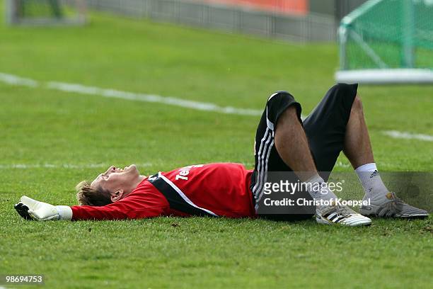Rene Adler lies on the pitch during the training session of Bayer Leverkusen at the training ground on April 27, 2010 in Leverkusen, Germany.