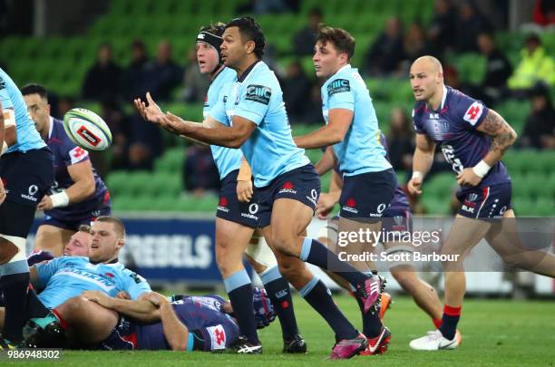Kurtley Beale of the Waratahs passes the ball during the round 17 Super Rugby match between the Rebels and the Waratahs at AAMI Park on June 29, 2018...