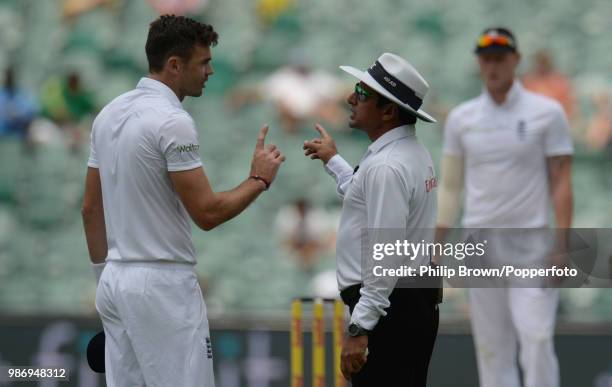 James Anderson of England argues with umpire Aleem Dar after receiving a second warning for running on the wicket and being stopped from completing...