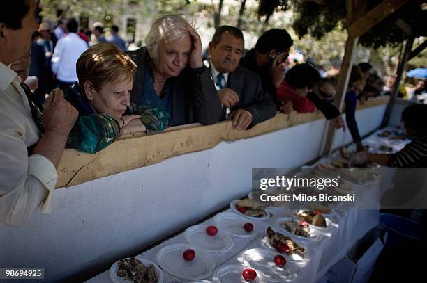 Pensioners queue for traditional lamb and eggs during Easter celebrations on April 4, 2010 in Livadia, Greece. Greece has requested financial...