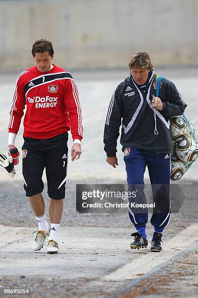 Rene Adler and goalkeeper coach Ruediger Vollborn walk to the training session of Bayer Leverkusen at the training ground on April 27, 2010 in...