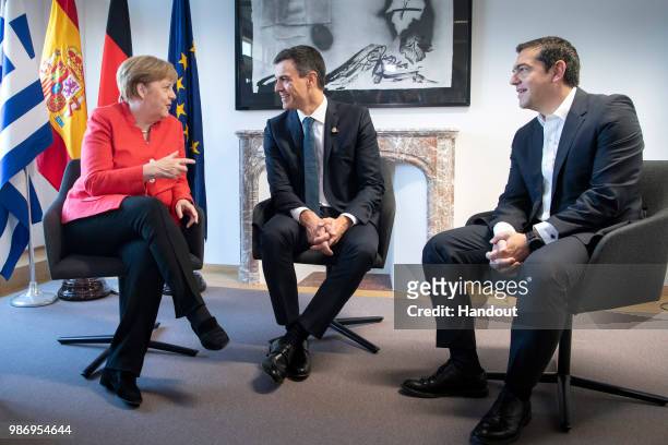 Chancellor Angela Merkel in conversation with Spanish Prime Minister Pedro Sanchez and Greek Prime Minister Alexis Tsipras at the beginning of the...