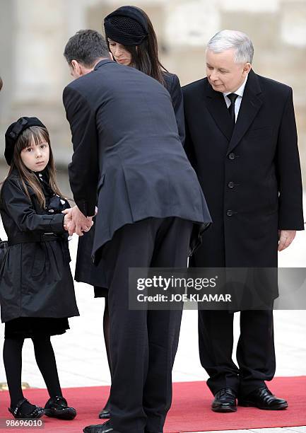 An unidentified official presents his condolences to Ewa, granddaughter of late President Lech Kaczynski next to her mother Marta and great-uncle...
