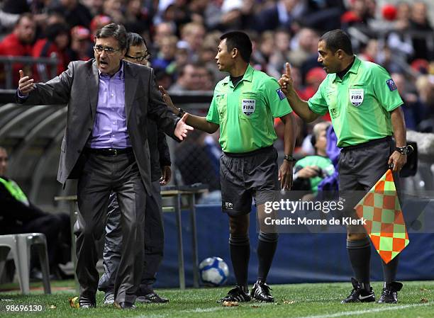 Officials talk to Shandong coach Branco Ivankovic during the AFC Champions League Group H match between Adelaide United and Shandong Luneng at...