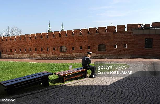 Policeman makes a call at the Wawel castle where late Polish President Lech Kaczynski and his wife Maria will be buried, in Krakow on April 18, 2010....