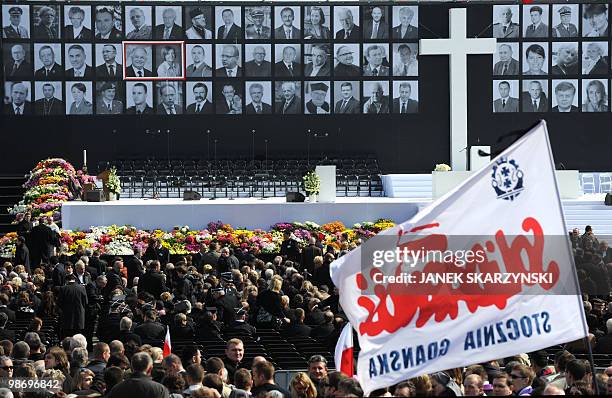 Solidarnosc flag flies as People gather at the Pilsudski square in Warsaw on April 17, 2010 prior to a memorial service for victims of Polish plane...