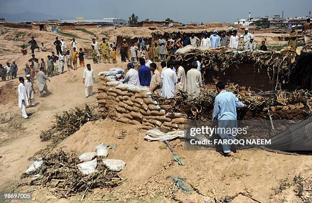 Pakistani Capital Development Authority workers destroy the foundations of a newly-constructed house in Afghan Basti, a slum area erected by Afghan...