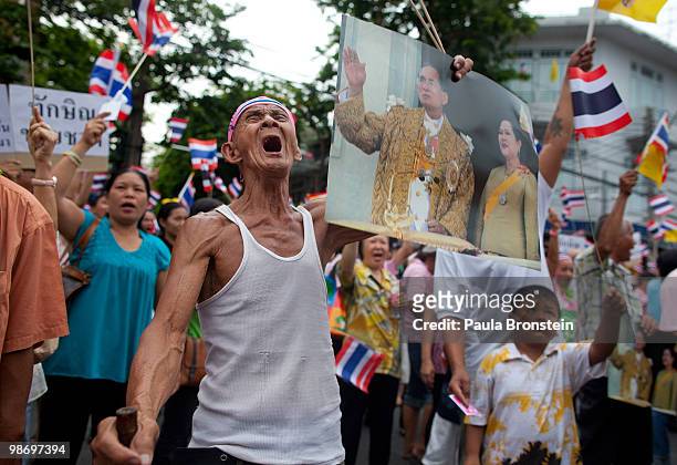 Thai protester Mr. Artee, age 80, cheers during a pro-government protesters rally in support of the Thai government and against the red shirts April...