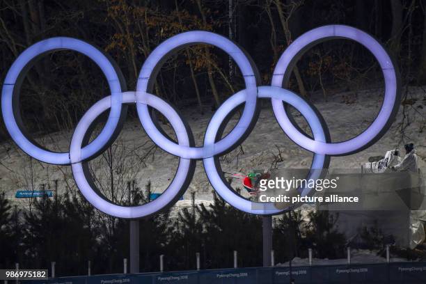 Johannes Hoesflot Klaebo from Norway behind the Olympic Rings during the men's free team sprint nordic skiing event of the 2018 Winter Olympics in...