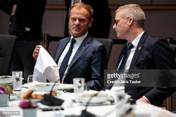 President of the European Council Donald Tusk takes his seat ahead of roundtable discussions on the final day of the European Council leaders' summit...