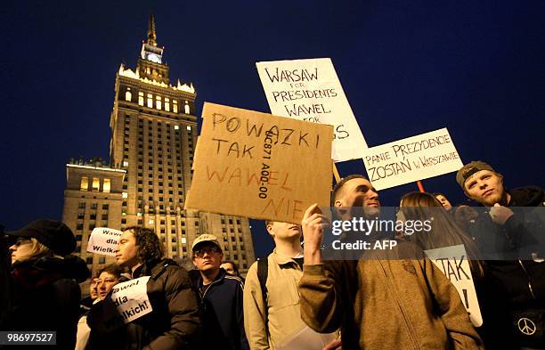 Group of people attends a protest demanding not to burry the late Polish presidential couple in Cracow's Wawel castle, in front of the Palace of...