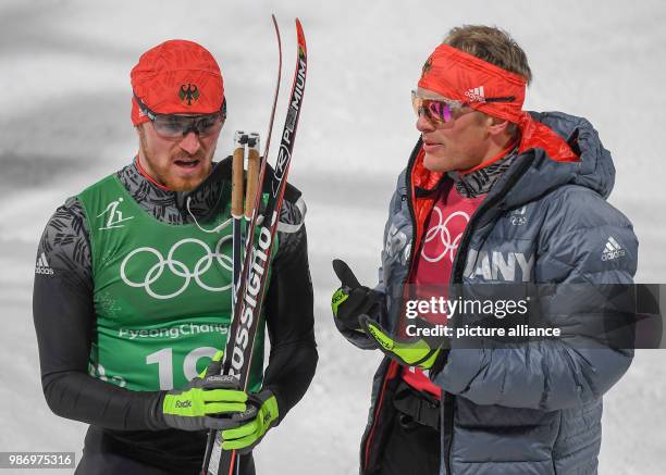 Sebastian Eisenlauer and Thomas Bing from Germany at the finish line during the men's free team sprint nordic skiing event of the 2018...