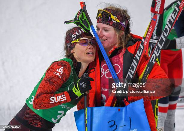 Laurien van der Graaff and Nadine Faehndrich from Switzerland at the finish line during the women's free team sprint nordic skiing event of the 2018...