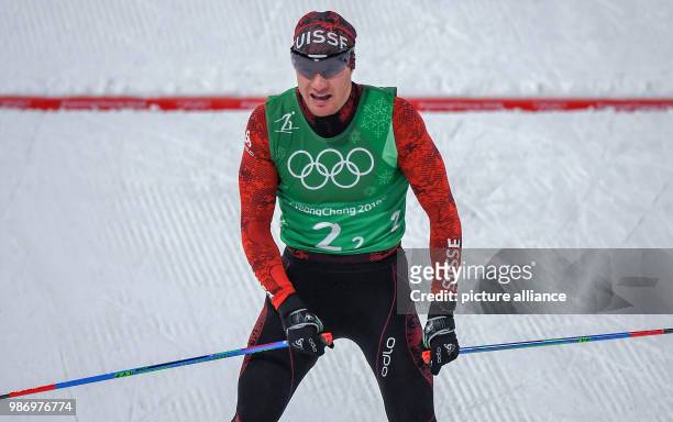 Dario Cologna from Switzerlanbd at the finish line during the men's free team sprint nordic skiing event of the 2018 Winter Olympics in the Alpensia...