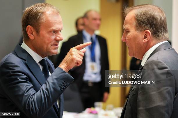 European Council President Donald Tusk speaks with Sweden's Prime Minister Stefan Lofven during the last day of the European Union leaders' summit,...