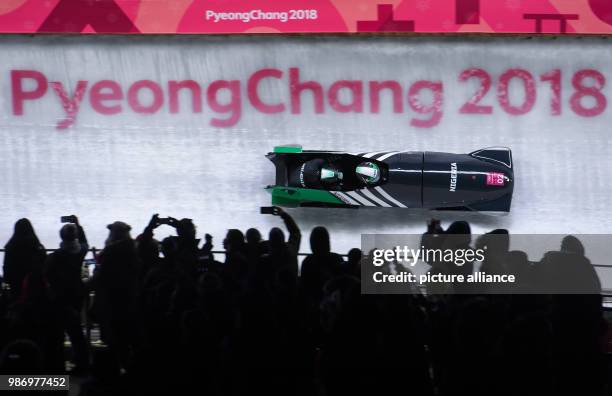 Pilot Seun Adigun and pusher Ngozi Onwumere from Nigeria sliding down the ice track during the women's two-woman bobsleigh event of the 2018 Winter...