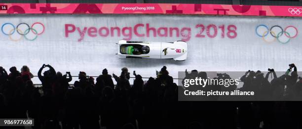 Pilot Jazmine Fenlator-Victorian and pusher Carrie Russell from Jamaica sliding down the ice track during the women's two-woman bobsleigh event of...