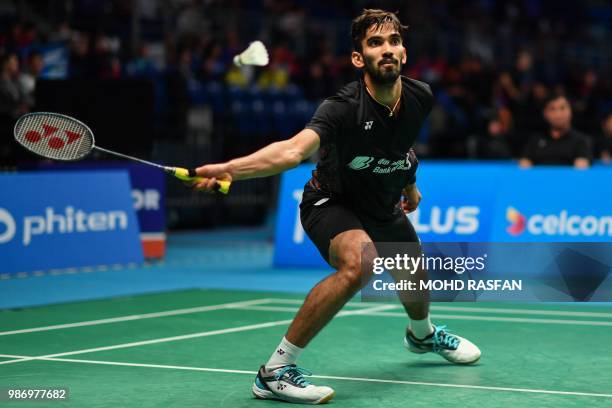 Srikanth Kidambi of India hits a return against Brice Leverdez of France during their men's singles quarterfinal match at the Malaysia Open Badminton...