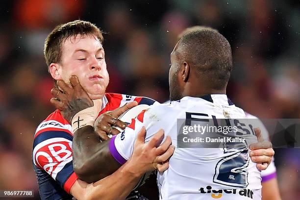 Luke Keary of the Roosters tackles Suliasi Vunivalu of the Storm during the round 16 NRL match between the Sydney Roosters and the Melbourne Storm at...