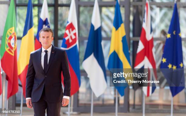 France's President Emmanuel Macron speaks to journalists as he arrives to take part in the second day of the European Union leaders' summit, without...