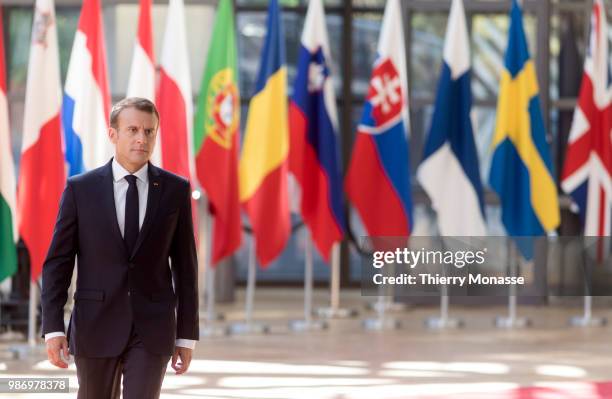 France's President Emmanuel Macron speaks to journalists as he arrives to take part in the second day of the European Union leaders' summit, without...