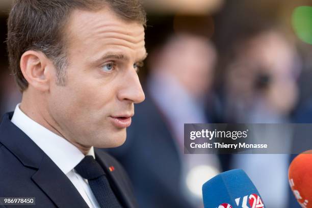 France's President Emmanuel Macron speaks to journalists as he arrives to take part in the second day of the European Union leaders' summit, without...