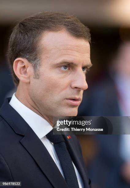 France's President Emmanuel Macron speaks to journalists as he arrives to take part in the second day of the European Union leaders' summit, without...