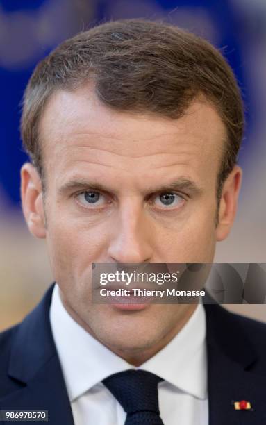 France's President Emmanuel Macron speaks to journalists as he arrives to take part in the second day of the European Union leaders' summit, without...