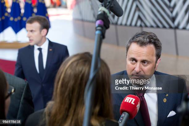 France's President Emmanuel Macron and the Luxembourg Prime Minister Xavier Bettel speak to journalists as he arrives to take part in the second day...