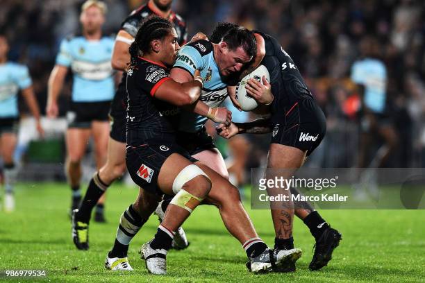 Paul Gallen is tackled during the round 16 NRL match between the New Zealand Warriors and the Cronulla Sharks at Mt Smart Stadium on June 29, 2018 in...