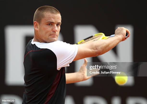 Mikhail Youzhny of Russia plays a backhand in his match against Lleyton Hewitt of Australia in action against during day three of the ATP Masters...