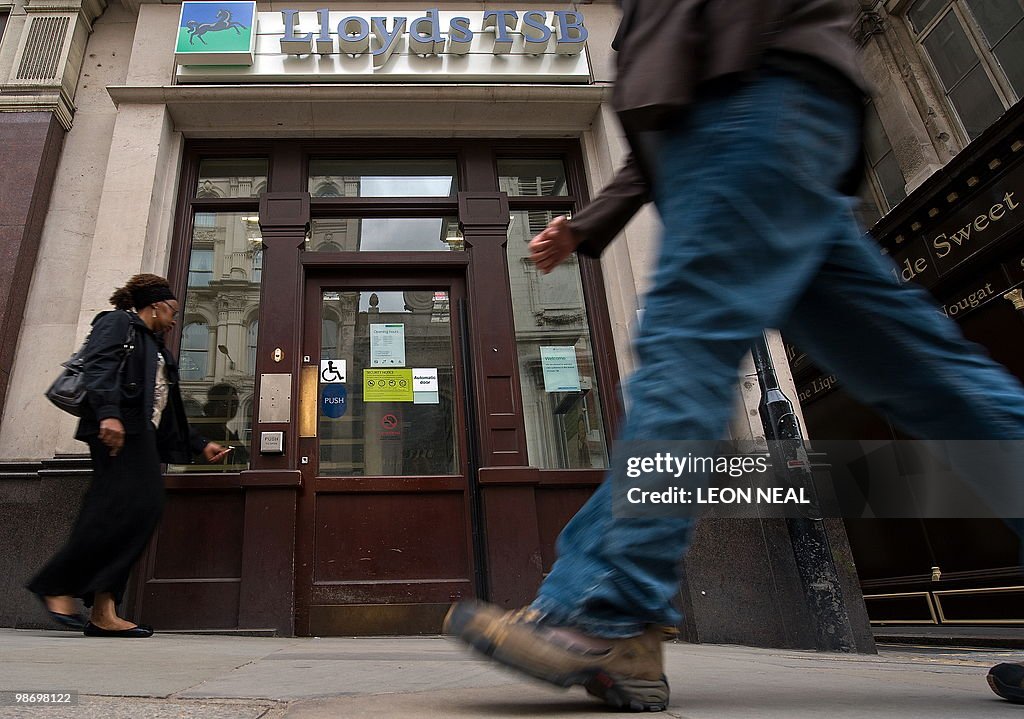 People walk past a branch of a Lloyds TS