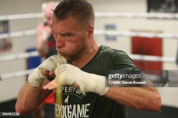 Brandon Cook dips under a rope throwing short punches and practicing defence. Ajax super welterweight boxer Brandon Cook has battled his way into...