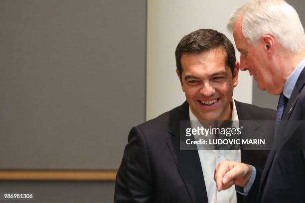 Brexit Chief Negotiator Michel Barnier speaks with Greece's Prime Minister Alexis Tsipras during the last day of the European Union leaders' summit,...