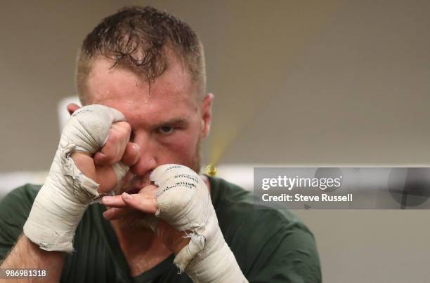 Brandon Cook dips under a rope throwing short punches and practicing defence. Ajax super welterweight boxer Brandon Cook has battled his way into...