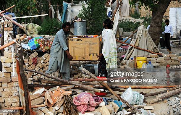 Pakistani Christians remove family belongings after their illegally constructed house was demolished by state workers in a slum area of Islamabad on...