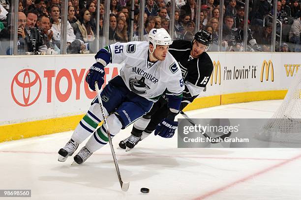 Shane O'Brien of the Vancouver Canucks skates with the puck against Brad Richardson of the Los Angeles Kings in Game Six of the Western Conference...