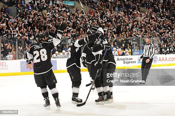 Jarret Stoll and Alexander Frolov of the Los Angeles Kings celebrate with teammates after a goal against the Vancouver Canucks in Game Six of the...