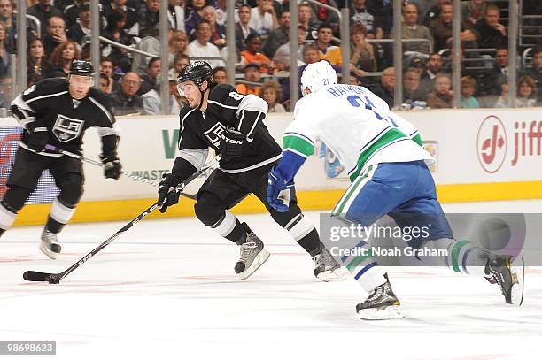 Drew Doughty of the Los Angeles Kings skates with the puck against Mason Raymond of the Vancouver Canucks in Game Six of the Western Conference...