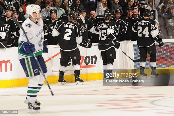 Matt Greene, Brad Richardson and Alexander Frolov of the Los Angeles Kings celebrate with the bench after a goal against the Vancouver Canucks in...