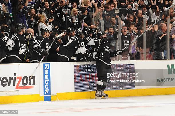 Drew Doughty of the Los Angeles Kings is grabbed by the bench after scoring a goal against the Vancouver Canucks in Game Six of the Western...