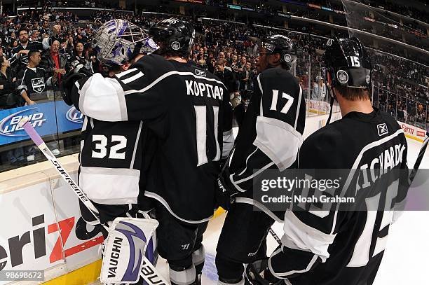 Jonathan Quick of the Los Angeles Kings is hugged by teammates Anze Kopitar, Wayne Simmonds and Brad Richardson after being defeated by the Vancouver...