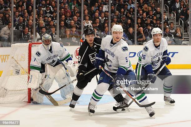 Dustin Brown of the Los Angeles Kings looks for the puck against Roberto Luongo, Christian Ehrhoff and Mikael Samuelsson of the Vancouver Canucks in...