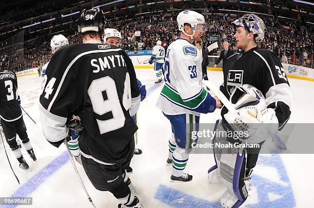 Ryan Smyth and Jonathan Quick of the Los Angeles Kings shake hands with Henrik Sedin of the Vancouver Canucks after Game Six of the Western...