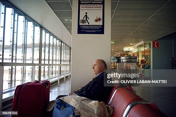 Passenger waits before boarding a flight on April 20, 2010 at Orly airport, south of Paris. The two main airports in Paris will progressively open...
