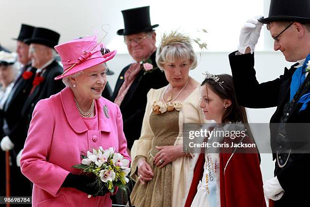 Queen Elizabeth II meets people dressed as Victorians as she arrives at the Venue Cymru Arena for a visit on April 27, 2010 in Llandudno, Wales. The...