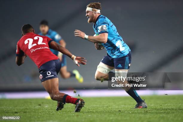 Blake Gibson of the Blues makes a break during the round 17 Super Rugby match between the Blues and the Reds at Eden Park on June 29, 2018 in...