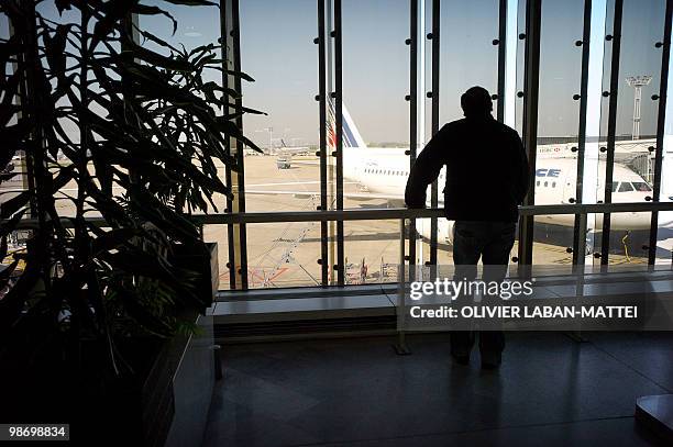 Passenger waits before boarding a flight on April 20, 2010 at Orly airport, south of Paris. The two main airports in Paris will progressively open...