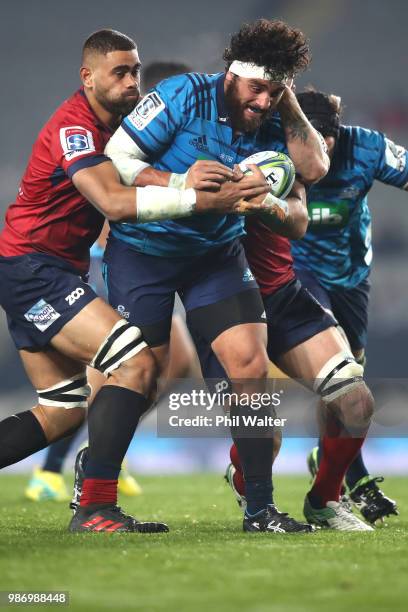 Alex Hodgman of the Blues is tackled during the round 17 Super Rugby match between the Blues and the Reds at Eden Park on June 29, 2018 in Auckland,...