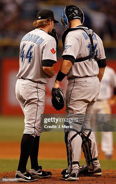 Pitcher Casey Janssen of the Toronto Blue Jays talks with catcher John Buck against the Tampa Bay Rays during the game at Tropicana Field on April...